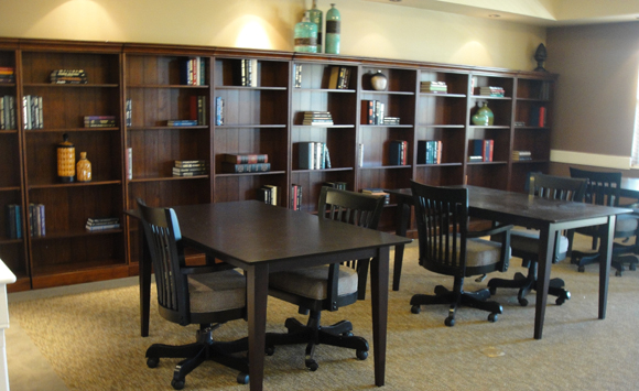 Stoney Brook assisted living, library with dark wood tables and banker's chairs.