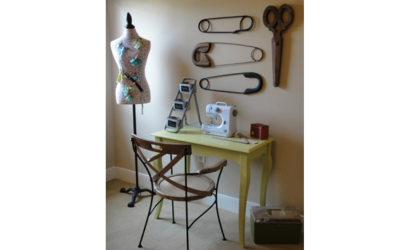 Memory point for female model bedroom in Stoney Brook. Sewing theme with oversize safety pin artwork and vintage sewing finds.