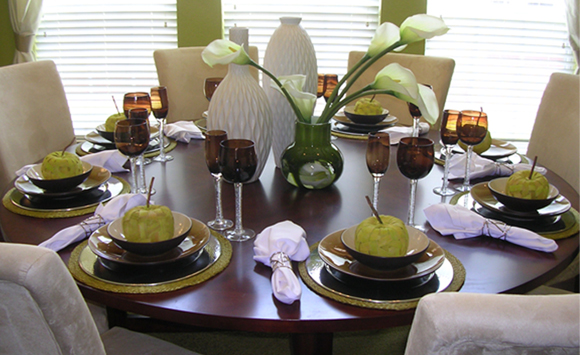 Circular dining table with tablescape (table settings)