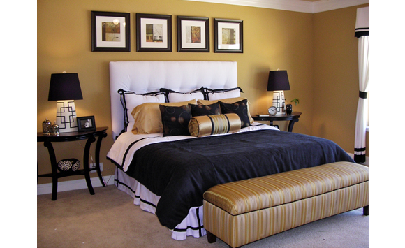 Classic Black and gold master bedroom. Custom designed upholstered white headboard with matching custom bedding, window treatment and bench.